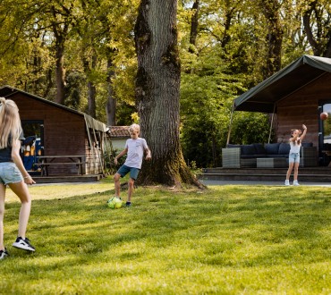 Safarilodge- kinderen spelen voor de tenten.jpg